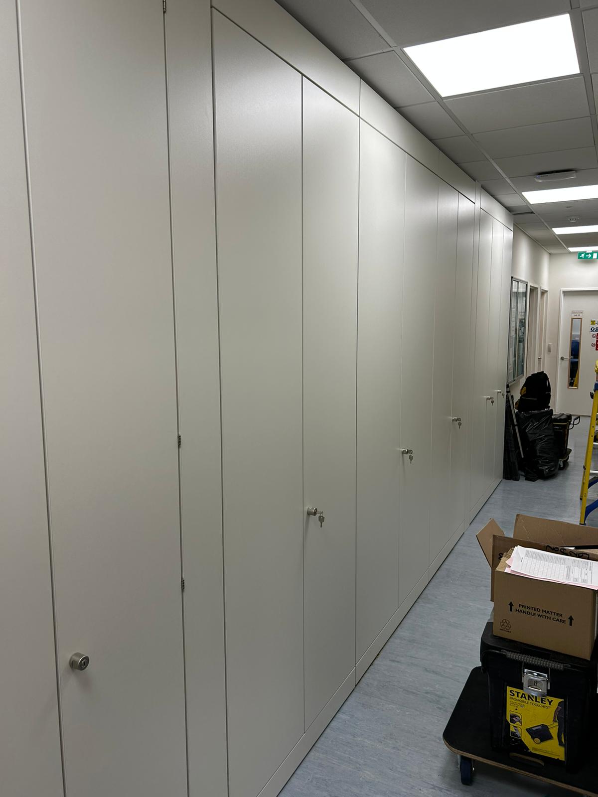white storage boxes along hallway